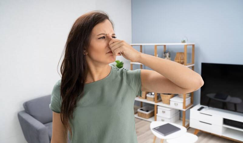 Woman is closing her noise inside a room