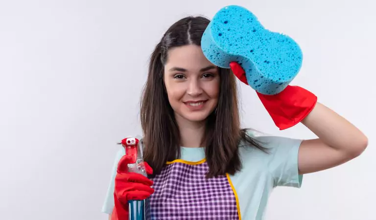 young woman with cleaning essentials ready to clean