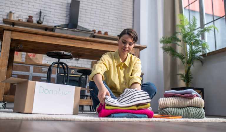 Woman in yellow top folding her cloths