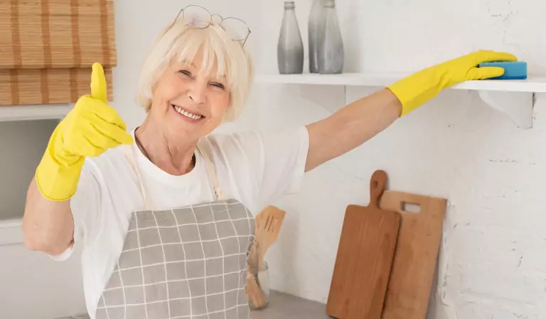 old age woman sprucing up her house