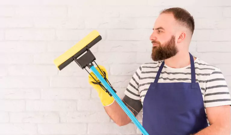 young man with a wiper ready to clean