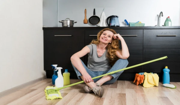 Woman posing while holding mop