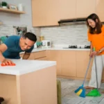 Asian man and woman cleaning their kitchen together