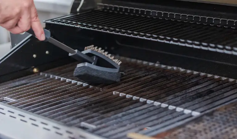 Cleaning outdoor gas grill before next grilling.