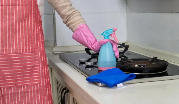 Cropped hand of person holding paper in clipboard at home
