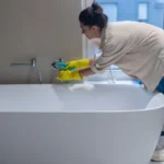 Disinfection. A housewife disinfecting the bathroom at home