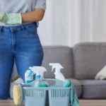 Woman hands for cleaning product in basket on table for home maintenance or living room spring cleaning cleaner container
