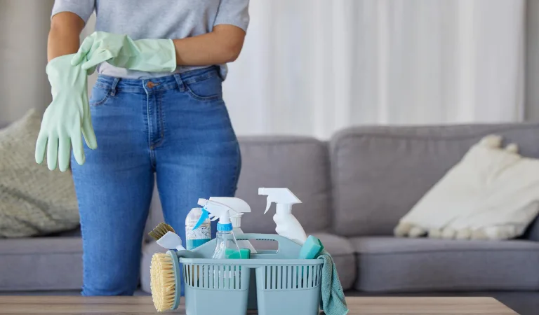Woman hands for cleaning product in basket on table for home maintenance or living room spring cleaning cleaner container